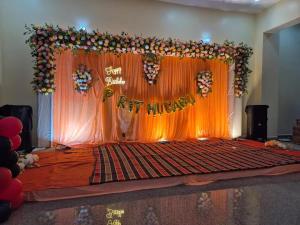 a stage with a sign that says happy anniversary at Hotel lakshmi in Goddā