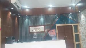 a room with a building with a blue roof at Hotel lakshmi in Goddā +3 photos
