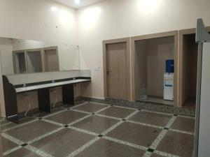 an empty room with a bench and a mirror at Hotel lakshmi in Goddā