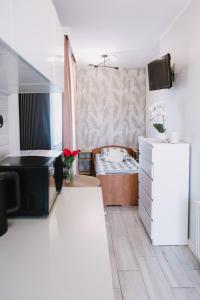 a living room with a couch and a bed at Motel Witnica in Witnica