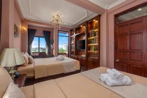 a bedroom with two beds and a chandelier at Vina Classic Hotel in Hue