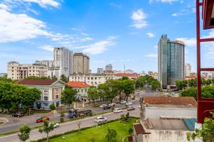 a city view of a street with cars and buildings at Vina Classic Hotel in Hue