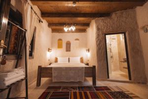 a bedroom with a bed and a walk in shower at Velum Cappadocia in Göreme