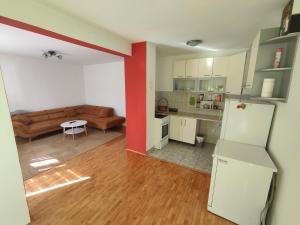 a living room with a couch and a table at Stan Foca N in Foča +2 photos
