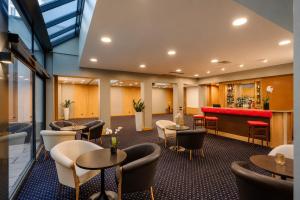 a restaurant with tables and chairs and a bar at City Life Hotel Poliziano, by R Collection Hotels in Milan