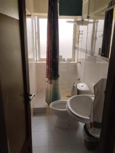 a bathroom with a toilet and a sink at Comfortable 2-Bedroom Apartment, Monte Sossego in Mindelo +16 photos