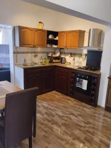 a kitchen with wooden cabinets and a stove top oven at Comfortable 2-Bedroom Apartment, Monte Sossego in Mindelo