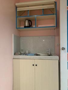 a kitchen with a sink and a counter top at Kenjie Apartment in Cordova