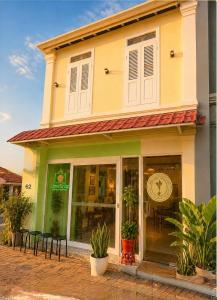 a store with tables and chairs in front of a building at Jade Guesthouse Jonker Street Melaka in Malacca