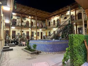 a building with a large blue fountain in a courtyard at El Emir in Samarkand
