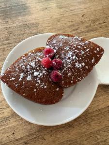a white plate with a piece of cake with berries on it at Douce escapade in Bourg-Saint-Andéol +8 photos