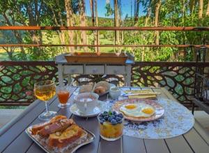 a breakfast table with food and wine on a deck at Douce escapade in Bourg-Saint-Andéol