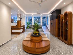 a lobby with a large wooden table and a plant at Kavin - The Chail Resort in Chail
