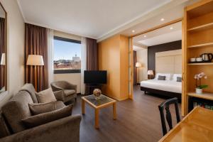 a hotel room with a bed and a living room at City Life Hotel Poliziano, by R Collection Hotels in Milan