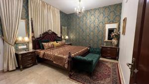 a bedroom with a bed and a chair in it at Waves P'opin Resort in Mahabalipuram