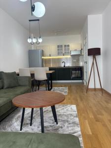 a living room with a couch and a table at Olive Šušanj Apartment in Bar +5 photos