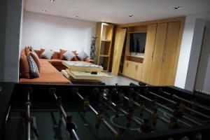 a view of a living room with a pool table at Villa Triplex avec piscine proche de la mer in El Harhoura