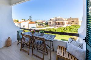 a table and chairs on a balcony with a view at Apartment Julio Pomar, swimming pool in Sagres