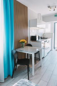 a kitchen with a table and chairs in a room at Motel Witnica in Witnica
