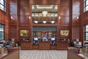 a lobby of a hotel with wooden walls and a salon at Silk Path Dong Trieu Golf Course & Villas in Trại Sưu +30 photos