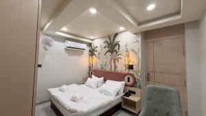 a small bedroom with a bed and two chairs at Shridhar inn in Alīganj