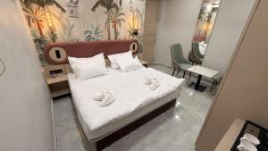 a bedroom with a bed with two towels on it at Shridhar inn in Alīganj