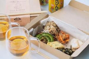 a box of food on a table with two glasses of beer at glampark Sesoko -Ocean Terrace- in Sesoko +24 photos