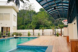 a swimming pool in the middle of a building at La Dimora luxury pool villa in Vythiri