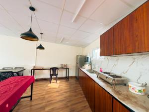 a kitchen with wooden cabinets and a counter top at La Dimora luxury pool villa in Vythiri