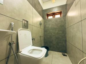 a bathroom with a toilet and a shower at La Dimora luxury pool villa in Vythiri +19 photos
