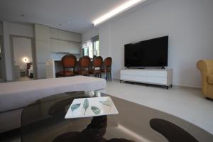 a living room with a couch and a tv at Avli Rooms in Himare