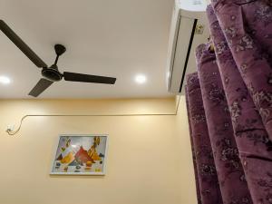 a ceiling fan in a room with purple curtains at Ratnadeep Palace - Near Kashi Vishwanath Temple & Ghats in Varanasi