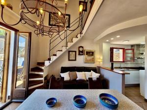 a living room with a couch and a staircase at EVH137 Can Biel in Tossa de Mar +31 photos