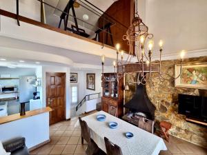 a dining room with a table and a fireplace at EVH137 Can Biel in Tossa de Mar