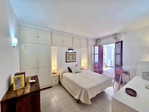a bedroom with a bed and a table and a desk at EVH137 Can Biel in Tossa de Mar