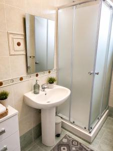 a bathroom with a sink and a shower at Optima Casa Vacanze II in Telese +13 photos