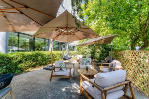 a patio with chairs and tables with umbrellas at Acca Sporting Milano - AA Hotels in Opera