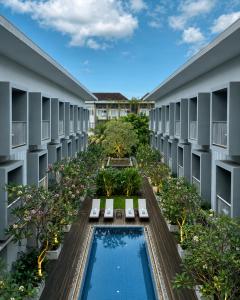 an aerial view of the courtyard of a building with a swimming pool at The Rooms Apartment Bali by ARM Hospitality in Denpasar