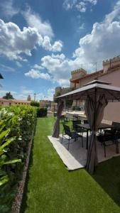 a patio with a table and chairs and an umbrella at Bijoux 2 in Celano