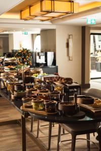 a buffet line with many pots and pans of food at Doubletree By Hilton Istanbul Macka in Istanbul