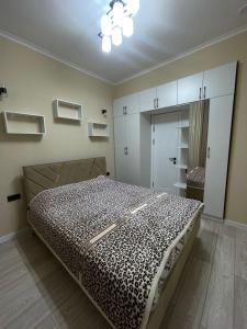 a bedroom with a bed in a room with cabinets at Коттедж Атлантис in Balykchy