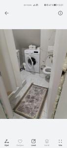 a bathroom with a washing machine and a toilet at Tinohovska vila in Hadžići