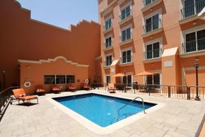 a swimming pool in front of a building at Holiday Inn Express Torreon by IHG in Torreón