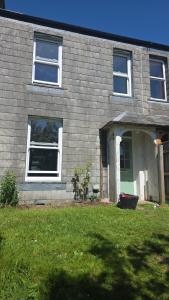 a house with a lawn in front of it at Lodge hill cottage in Liskeard