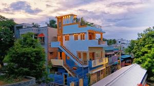a tall building with a blue and yellow at Sri Ram Villa in Rāmeswaram