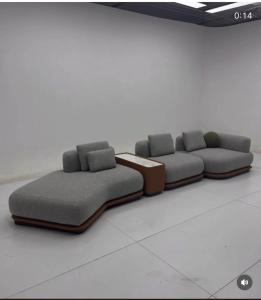 two couches sitting in a room with at JOHNOATCH APARTMENt in Ibasa