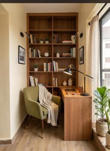 a room with a desk with a chair and a lamp at JOHNOATCH APARTMENt in Ibasa