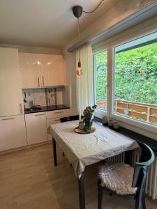 a kitchen with a table and a large window at Apollo in Saas-Fee