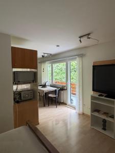 a living room with a kitchen and a dining room at Apollo in Saas-Fee