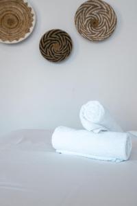 a stack of white towels and some oreos at Alami Apartment Seminyak in Seminyak
